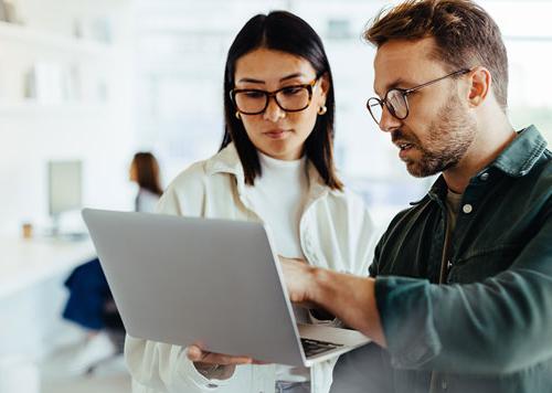 Man and Woman looking at a laptop together